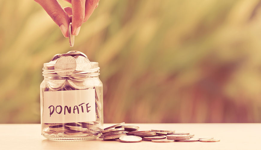 a close up of an old Bible with passages highlighted in green, pink, and orange