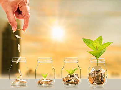 two pairs of hands each clasped together in prayer on top of a Bible