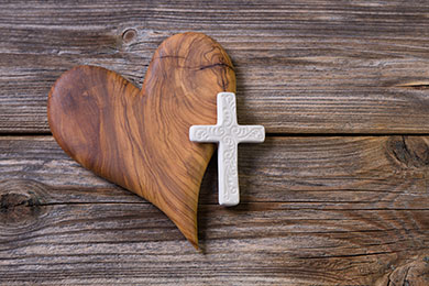 antique carpentry hand tools on a wooden table in an old barn with a beam of sunlight shining on them